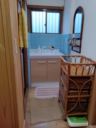 a bathroom with a sink and a mirror at Bayside House Shiosai - Vacation STAY 15343 in Kumano