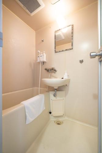 a bathroom with a sink and a toilet and a mirror at maison elegance - Vacation STAY 15798 in Tokyo