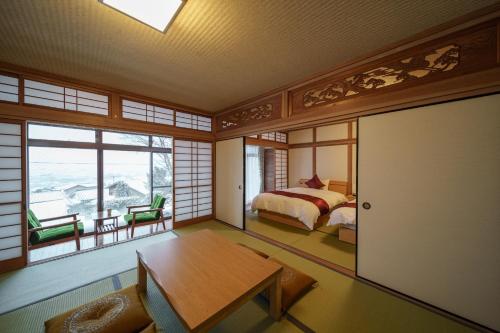 a room with a bed and a table in a room at Osugi no Yado - Vacation STAY 43977v in Yufuin