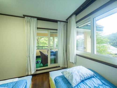 a bedroom with a bed and a large window at Sanso Seseragi - Vacation STAY 15301 in Nasu