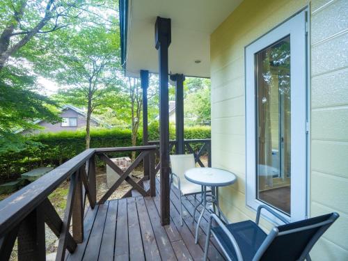a porch with chairs and a table on a deck at Sanso Seseragi - Vacation STAY 15301 in Nasu