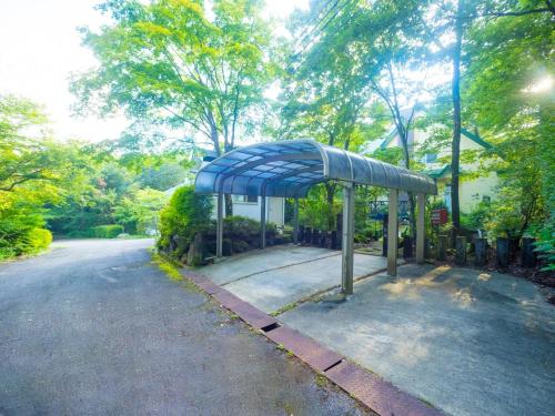 a bus stop with a blue canopy on the side of a road at Sanso Seseragi - Vacation STAY 15301 in Nasu