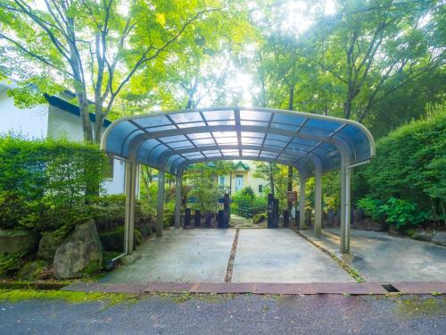 a blue pavilion in the middle of a garden at Sanso Seseragi - Vacation STAY 15301 in Nasu