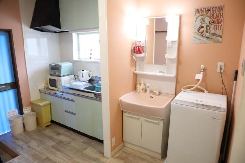 a small kitchen with a sink and a counter at blue dot aoshima beach house - Vacation STAY 15358 in Miyazaki
