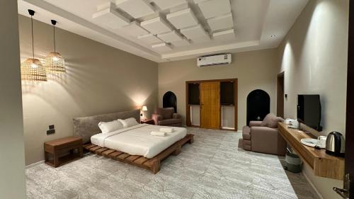 a bedroom with a bed and a living room at Aryaf hostel in Nizwa
