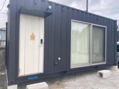 a black shipping container with two windows at Ko-eda Village - Kujukuri Beach Line - Vacation STAY 39912v in Iioka