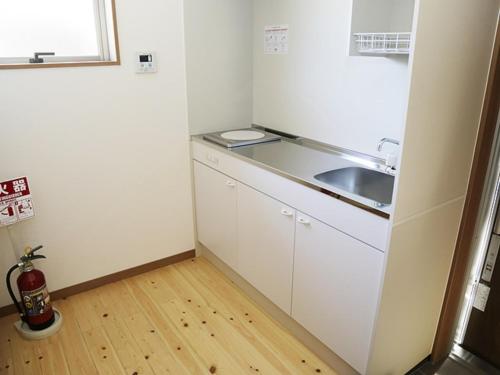 a small kitchen with a sink and a counter at Hisetsu no Taki Campsite - Camp - Vacation STAY 42072v in Ōzato