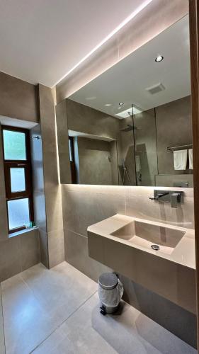 a bathroom with a sink and a mirror at Aryaf hostel in Nizwa