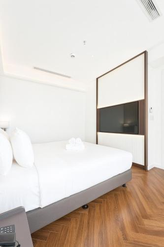 En eller flere senge i et værelse på La Passion Saigon Hotel