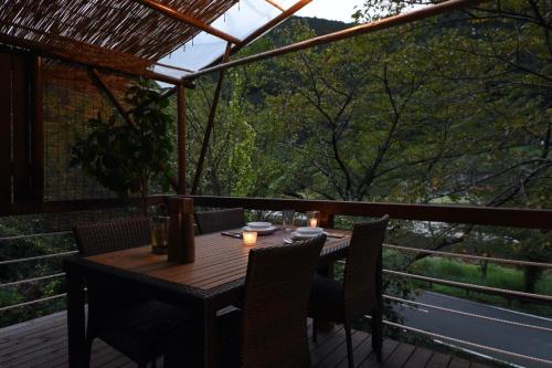 a wooden table and chairs on a deck at Angler's Base SHIMOKITAYAMA Fishing Lodge - Vacation STAY 73805v in Kami-ikehara