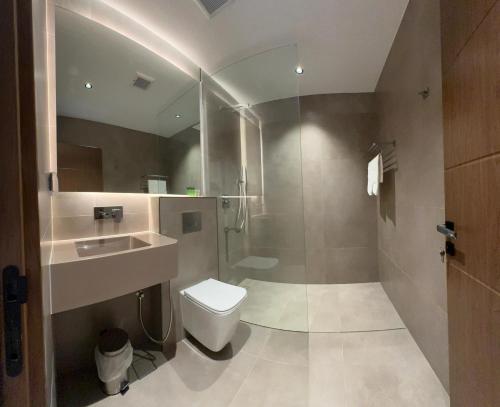 a bathroom with a toilet and a sink and a shower at Aryaf hostel in Nizwa