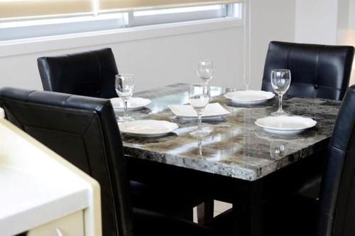 a dining room table with glasses and plates on it at Red Dragon - Vacation STAY 15430 in Urasoe