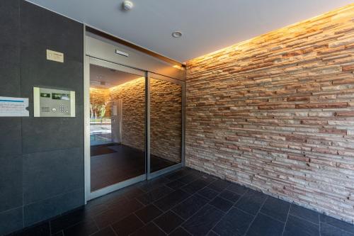 a room with a brick wall and a mirror at VIDA Hakata 301 - Vacation STAY 63191v in Sumiyoshi