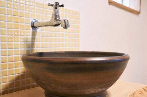a bathroom sink with a copper faucet on a counter at Fujino Minshuku - Vacation STAY 65039v in Bizen