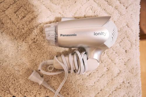 a hair dryer is plugged into a wall at Fujino Minshuku - Vacation STAY 65039v in Bizen