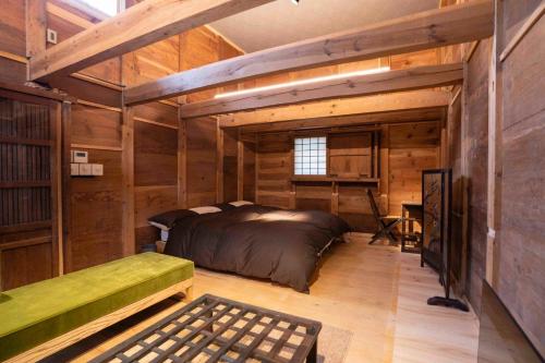 a bedroom in a log cabin with a bed and a desk at MAGONI - Vacation STAY 66665v in Kaga