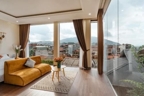 a living room with a couch and a balcony at Love House Homestay SAPA in Sa Pa
