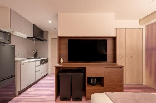 a kitchen with a flat screen tv in a kitchen at Hotel TOKI 季 in Tokyo