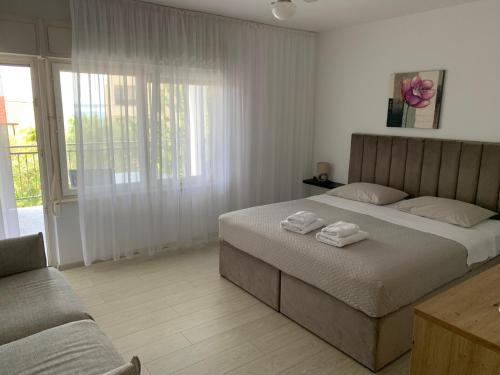 a bedroom with a bed with two towels on it at Room with Balcony and Sea View in Zadar