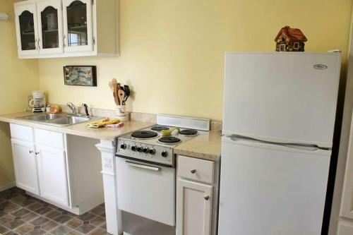a kitchen with white appliances and a white refrigerator at River Falls Lodging -Black Hills, South Dakota in Hot Springs