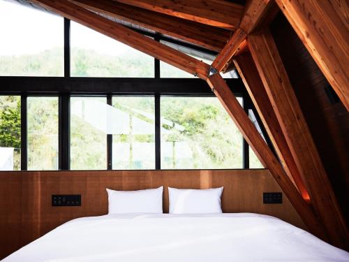 a bedroom with two white pillows in a room with windows at CAP MARTIN Funny house - Vacation STAY 68833v in Minamiboso