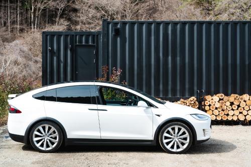 a white car parked next to a pile of logs at G,O,A,T - Vacation STAY 79413v in Tsuru 