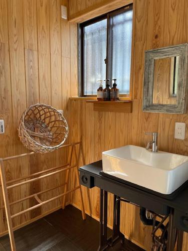 a bathroom with a sink and a mirror at HanareSou - Vacation STAY 15441 in Kirishima