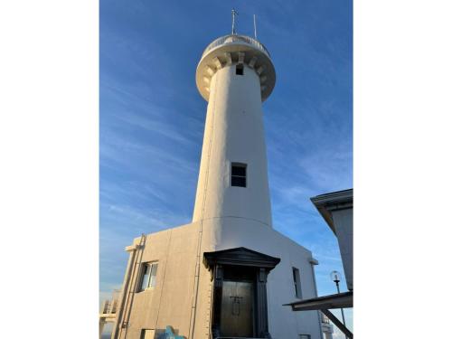 a lighthouse on the side of a building at Seaside Garage Shima - Vacation STAY 77073v in Shima