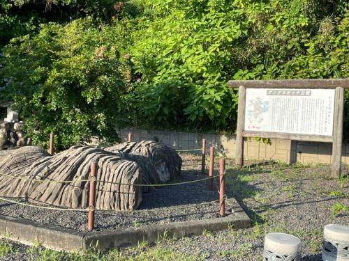 a bed with a blanket on the ground next to a sign at Seaside Garage Shima - Vacation STAY 77073v in Shima