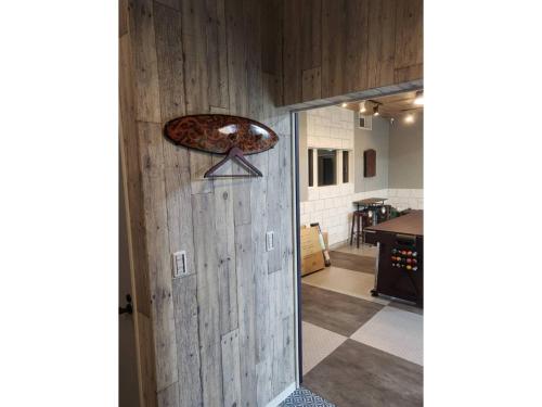 a door to a kitchen with a pizza on the wall at Seaside Garage Shima - Vacation STAY 77073v in Shima