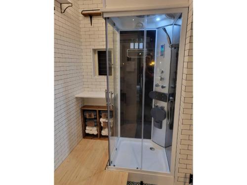 a glass shower in a bathroom with a wall at Seaside Garage Shima - Vacation STAY 77073v in Shima