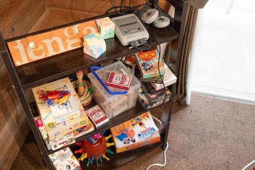 a book shelf filled with toys and other items at Sunland O66 - Vacation STAY 72793v in Saikubo