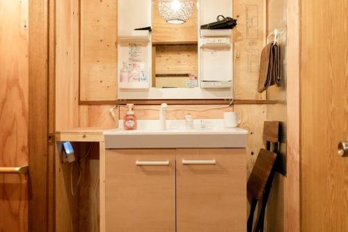 a small bathroom with a sink and a microwave at Sunland O66 - Vacation STAY 72793v in Saikubo