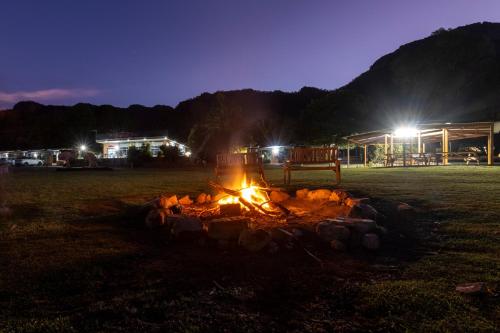 a fire pit in a field at night at The Grampians Motel in Halls Gap