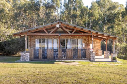 a log cabin with a porch and a gate at The Grampians Motel in Halls Gap