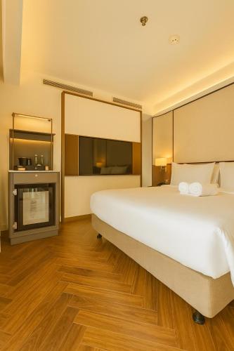 En eller flere senge i et værelse på La Passion Saigon Hotel