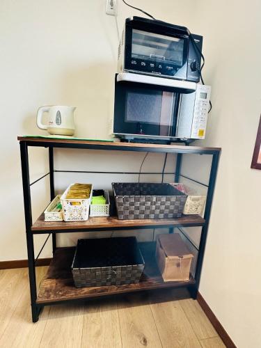 a shelf with a microwave and a toaster oven at Shirakata Token Residence 701 - Vacation STAY 76938v in Matsue