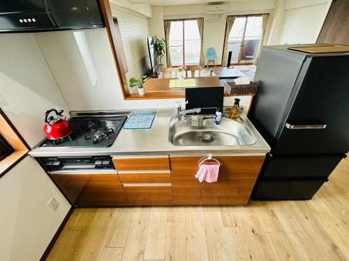 a kitchen with a sink and a refrigerator at Shirakata Token Residence 701 - Vacation STAY 76938v in Matsue