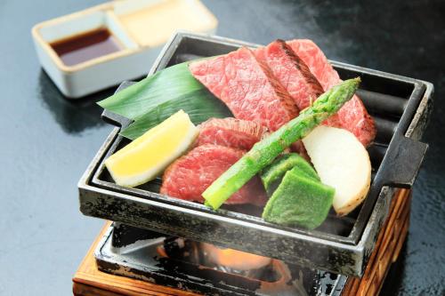 a tray of meat and vegetables on a grill at Kaike Fuga in Yonago