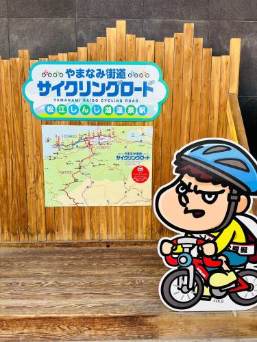 a sign with a boy riding a motorcycle at Shirakata Token Residence 701 - Vacation STAY 76938v in Matsue