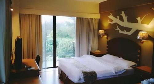 Katil atau katil-katil dalam bilik di Casuarina Hotel
