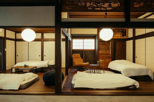 a room with three beds and a chair at Sea saw - Vacation STAY 91738v in Isumi