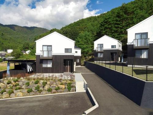 a couple of white houses in front of a mountain at Asama no Iori - Vacation STAY 00952v in Fujiyoshida