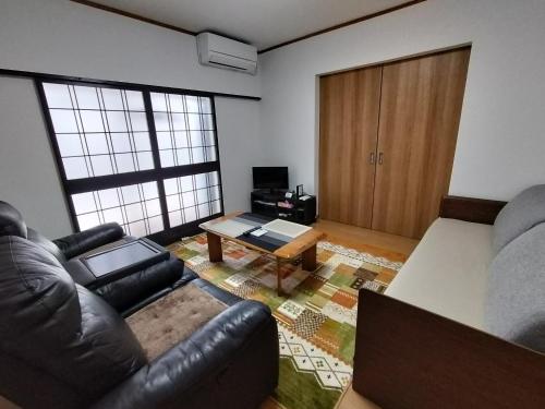 a living room with a couch and a table at Guesthouse Kirishima - Vacation STAY 02754v in Kirishima
