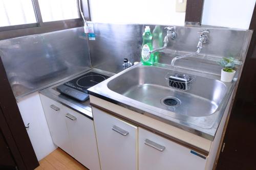a small kitchen with a sink and a stove at green park heights - Vacation STAY 15686 in Musashino