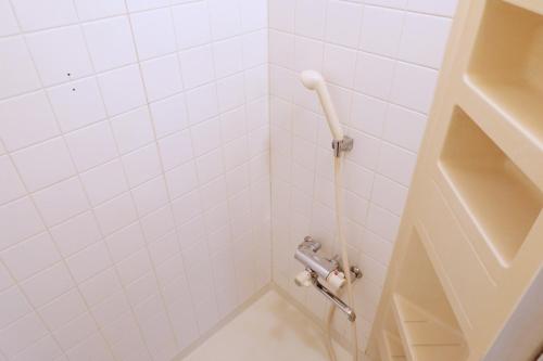 a bathroom with a shower with white tiles at green park heights - Vacation STAY 15685 in Musashino