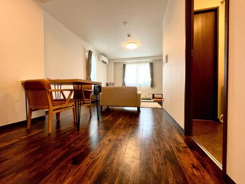 a living room with a table and chairs and a dining room at Hakodatekan - Vacation STAY 07879v in Hakodate