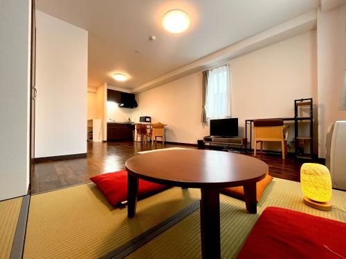 a living room with a table and a living room at Hakodatekan - Vacation STAY 07877v in Hakodate