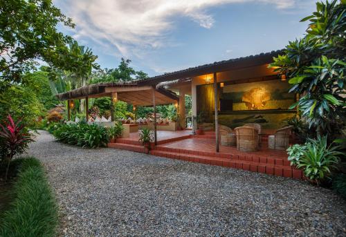 a house with a garden with a patio at Green Mansions Jungle Resort in Sauraha