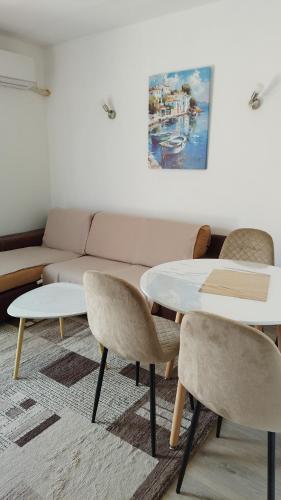a living room with a couch and tables and chairs at Vaske in Bar